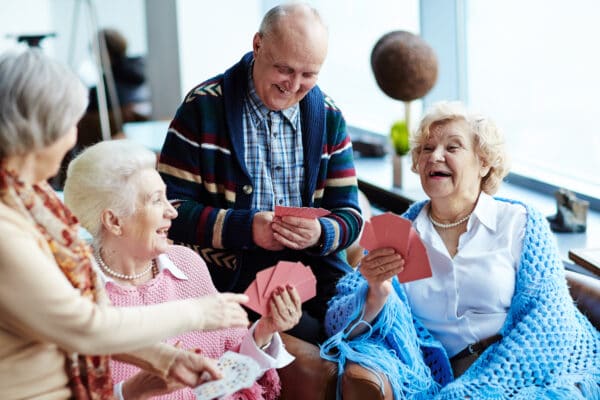 Group of older people playing cards