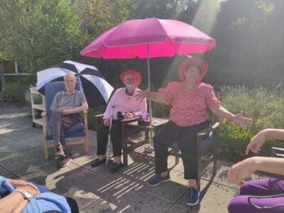 Regular Acredale attendees in garden enjoying the sunshine